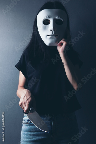 woman attacks with a kitchen knife in an anonymous mask