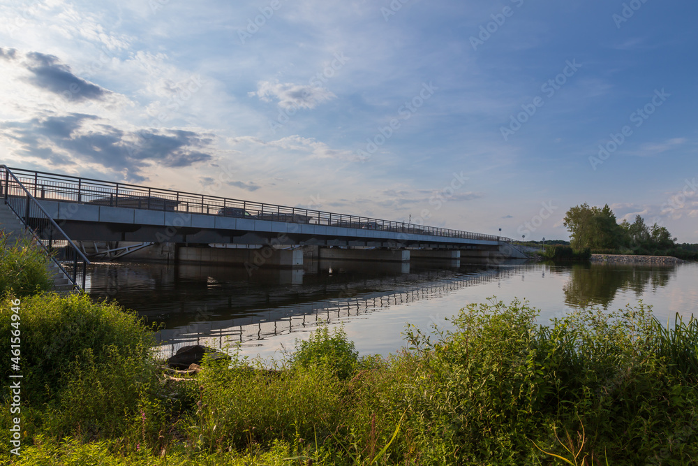 Iron bridge over the Nove Mlyny reservoir in the Czech Republic. On background are trees and blue sky with white clouds.