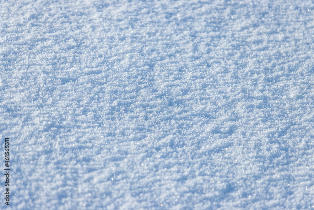 Snow surface close-up. Winter background with snow texture and snowflakes on the ground. Perfect for Christmas and New Year design.