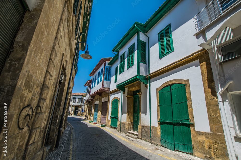 Facade of turkish traditional terraced houses with green doors and windows
