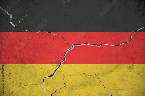 An image of the flag of Germany on a wall with a crack.
