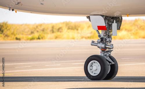 The plane is preparing to fly at the airport. Airplane on the runway at the airport. The turbine of the aircraft is warming up, the landing gear is preparing for flight. The plane flies in the sky.