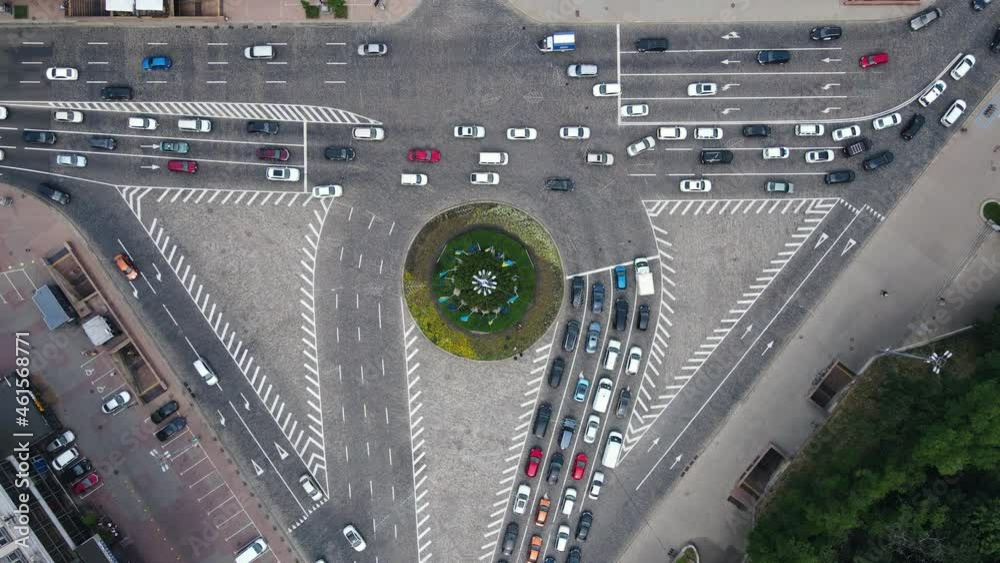 Aerial top view of cars driving on busy city road at intersection with markings Aerial top view of cars driving on busy city road at intersection with markings