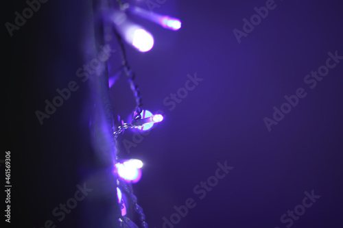 Christmas or New Year festivre blurred background with colorful garland lights photo