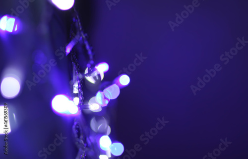 Christmas or New Year festivre blurred background with colorful garland lights