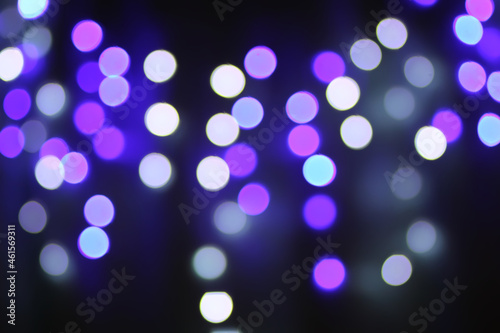 Christmas or New Year festivre blurred background with colorful garland lights photo