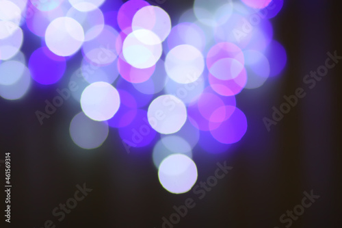 Christmas or New Year festivre blurred background with colorful garland lights photo