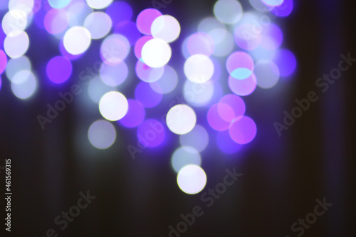 Christmas or New Year festivre blurred background with colorful garland lights photo