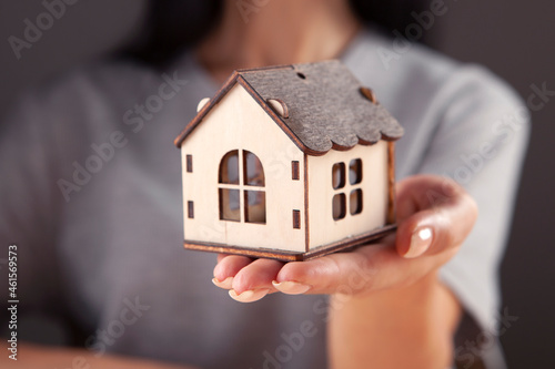 woman holding a house model
