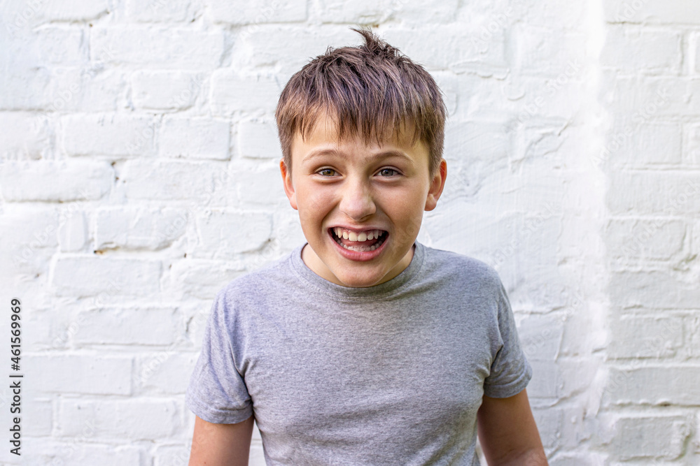 Surprised looking and smiling teenager. funny boy grinned and grimaced. Surprised looking and smiling teenager. funny boy grinned and grimaced.