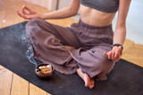 Wellness, health mental.Cropped young female meditates yoga at home with aromatherapy, sitting on floor.Care, Wellness , meditation, spa, relax occultism, spiritual cleansing. Close-up photo of smoke