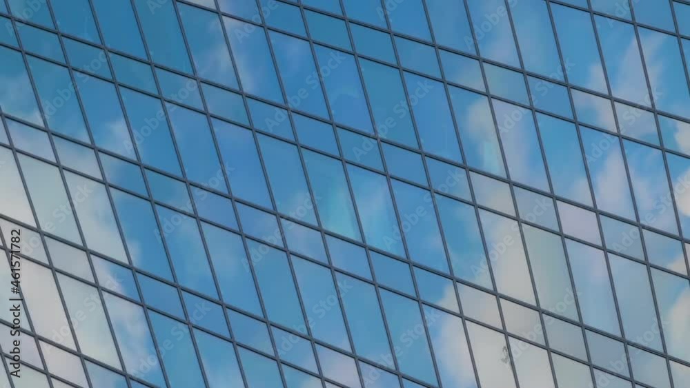 Timelapse - reflection of moving white clouds and blue sky in glass wall of modern tall building, skyscraper - low angle view. Architecture, corporate, business, urban, time lapse, cityscape concept Timelapse - reflection of moving white clouds and blue sky in glass wall of modern tall building, skyscraper - low angle view. Architecture, corporate, business, urban, time lapse, cityscape concept