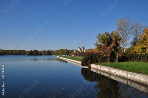 Panoramic view of the pond and the bell tower. The banks of the pond with a concrete frame. © Viacheslav