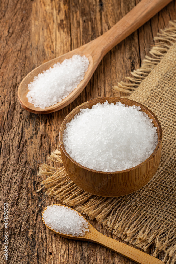 Coarse salt in bowl on wooden background. Coarse salt in bowl on wooden background.