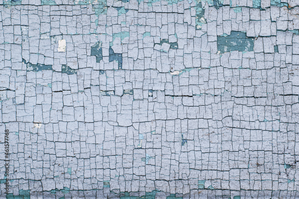 Naklejka premium Part of a wooden surface with cracked blue paint