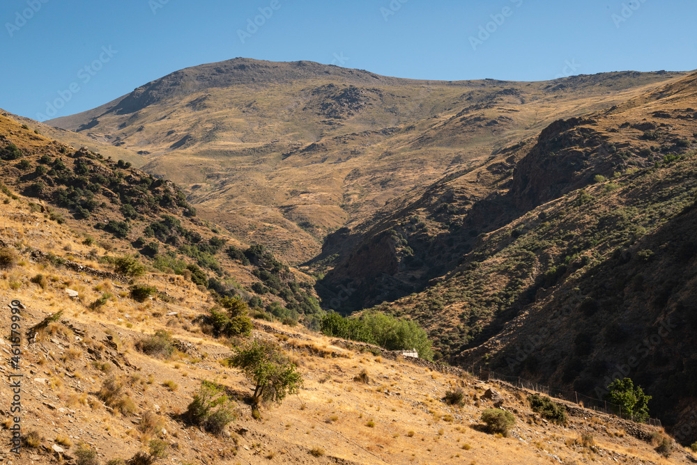 Scenic view of the Poqueira valley with the summit of Mount Mulhacén in the distance, seen from a hiking trail near Capileira, Las Alpujarras, Sierra Nevada National Park, Andalusia, Spain