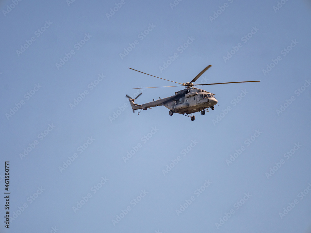 Military helicopter flies high in sky
