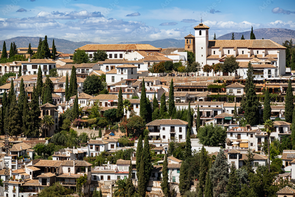 Panorama of the Albaicín, the historic city center of Granada with its characteristic whites houses, and the San Nicolás church and viewpoint, seen from the Alhambra, Andalusia, Spain