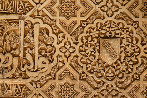Close up of moorish ornaments at the Court of the Myrtles (Patio de los Arrayanes), part of the Nasrid palaces, Alhambra de Granada UNESCO World Heritage Site, Granada, Andalusia, Spain photo
