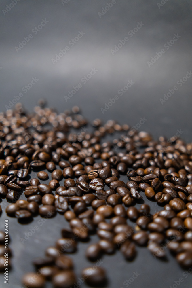 Pile of roasted coffee beans with dark gray background Pile of roasted coffee beans with dark gray background