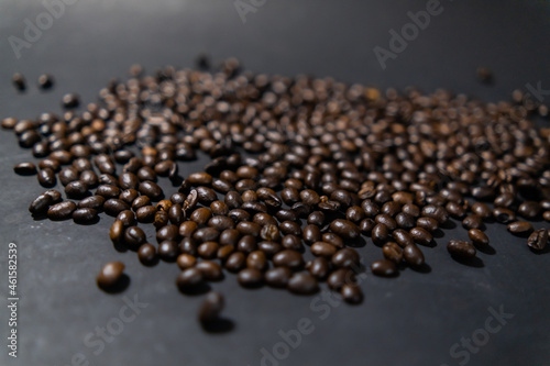 Pile of roasted coffee beans with dark gray background