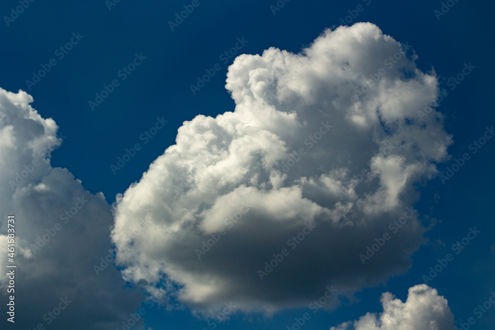 Cumulus. White summer clouds in the sky. Summer weather in the middle lane. Details of the atmosphere. Cumulus. White summer clouds in the sky. Summer weather in the middle lane. Details of the atmosphere.