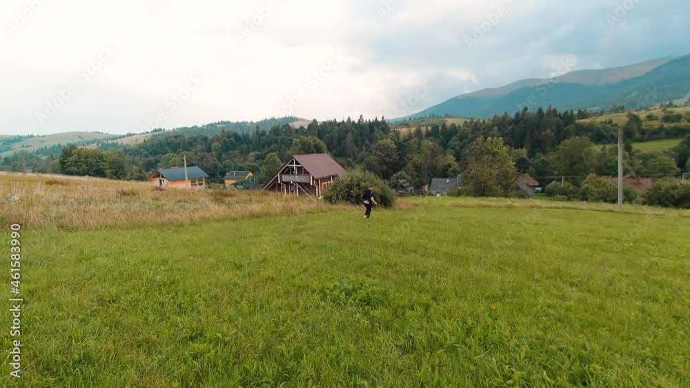 Woman traveler walks in the mountains on a rainy day. Enjoying nature and a happy life, adventure. Woman traveler walks in the mountains on a rainy day. Enjoying nature and a happy life, adventure.