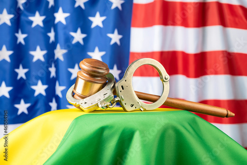 Gavel and handcuffs on rainbow flag