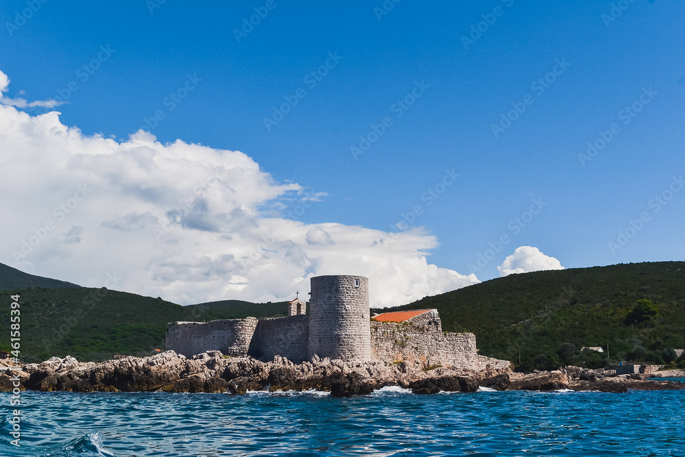 An island with the former Austrian fortress Arza. Mamula Island. Bay of Kotor, Adriatic Sea. Close-up view from the sea from the yacht.