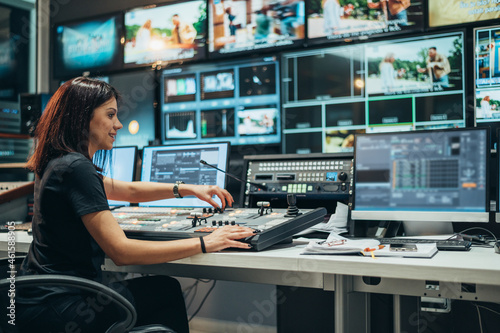Vászonkép Young beautiful woman working in a broadcast control room on a tv station