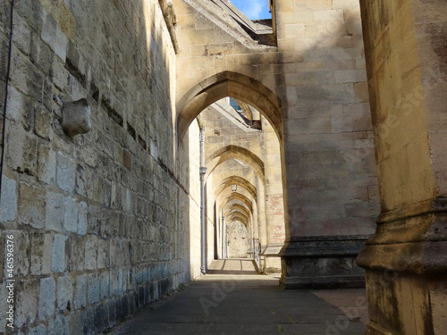 Fototapeta Naklejka Na Ścianę i Meble -  Nice walkway under flying buttresses of Winchester cathedral, England, UK