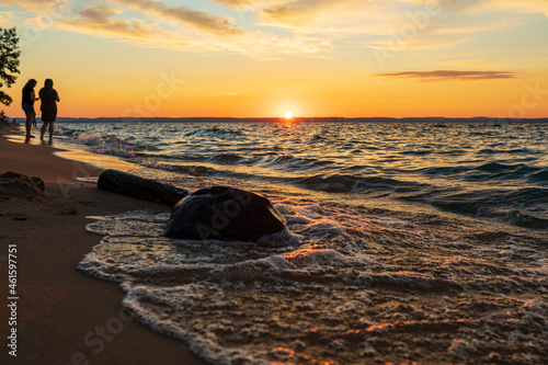 People watching sunset along beach on Lake Michigan.   photo