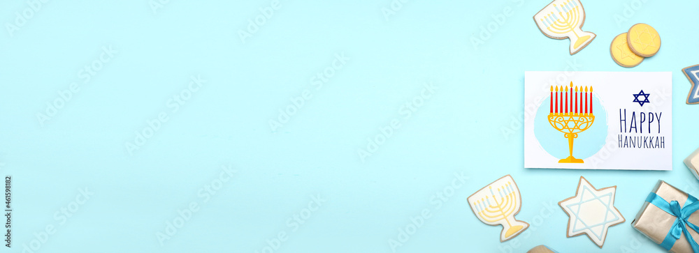 Tasty cookies and greeting card for Hanukkah on color background with space for text Tasty cookies and greeting card for Hanukkah on color background with space for text