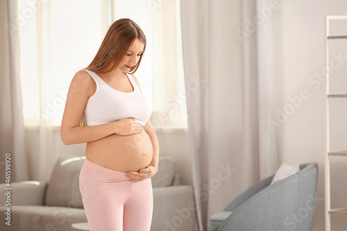 Young pregnant woman practicing yoga indoors Free Download Young pregnant woman practicing yoga indoors - GFXLoad