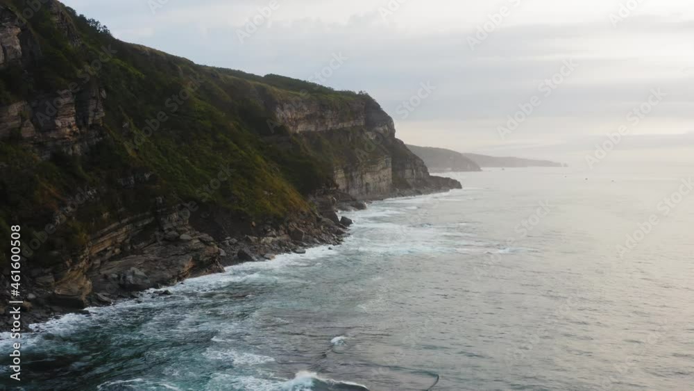 Aerial view of the picturesque high coastline, sharp cliffs and raging sea Aerial view of the picturesque high coastline, sharp cliffs and raging sea