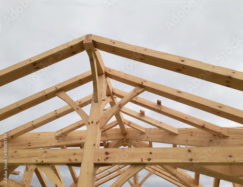 new roof under construction with beams and rafters exposed