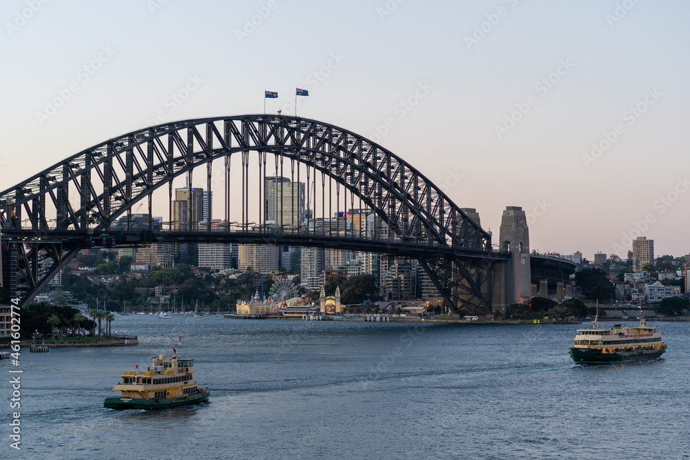 city harbour bridge with ferries at sunset
