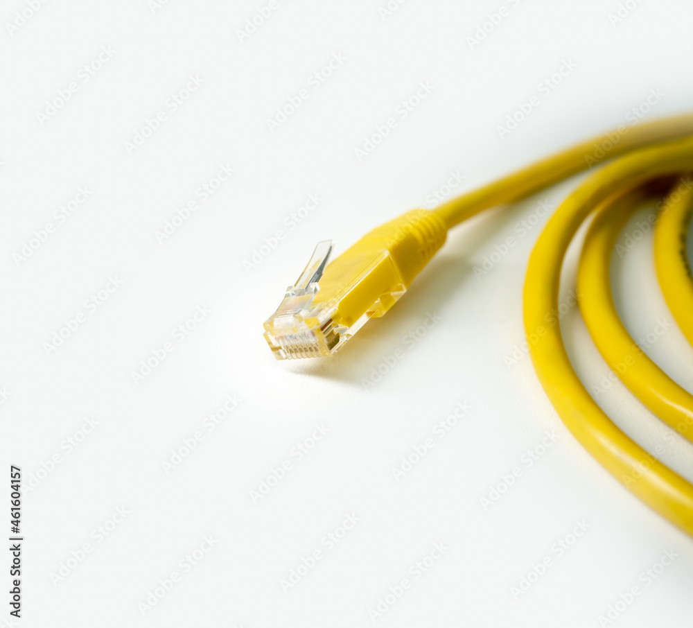 yellow network cable on white background. cat 5 wire with rj45 tip. copy space yellow network cable on white background. cat 5 wire with rj45 tip. copy space