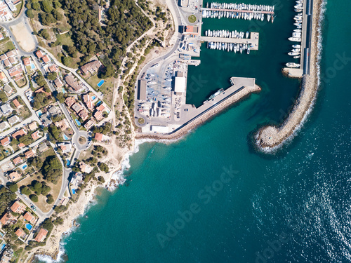 Top view of white pleasure yachts moored in port off coast of small Spanish town of Torredembarra