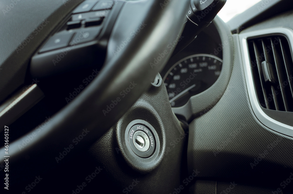 Control buttons and ignition switch on the car steering wheel.