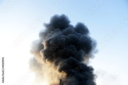 Thick dark smoke over a fire