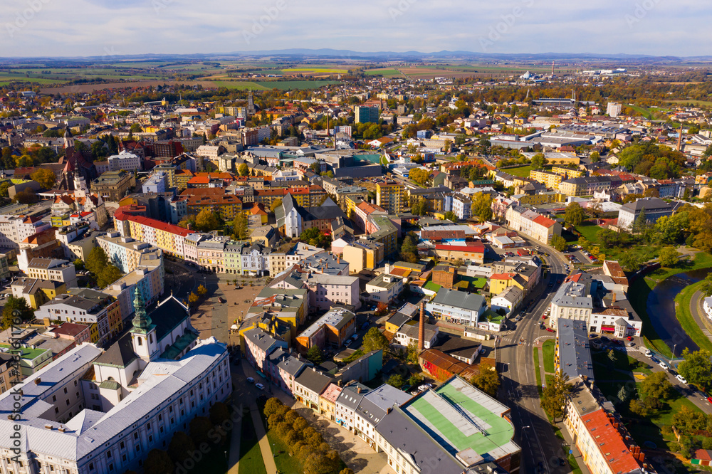 Panoramic aerial view of autumn scape of Czech city of Opava on bank of small river on sunny day, Moravian-Silesian Region