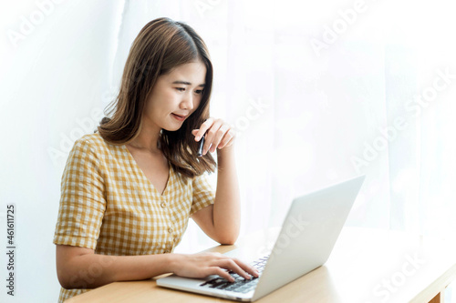 Entrepreneur concept a young businesswoman typing on a laptop to reply emails to her customers
