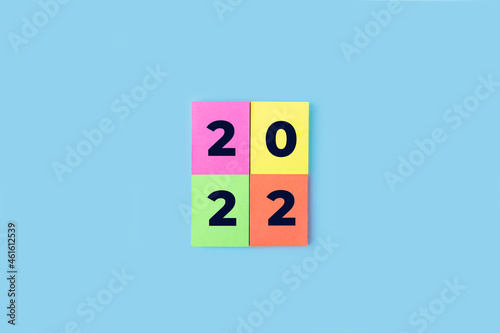 Inscription numbers 2022 on colorful stickers. New year concept. Sticky note, copy space for text