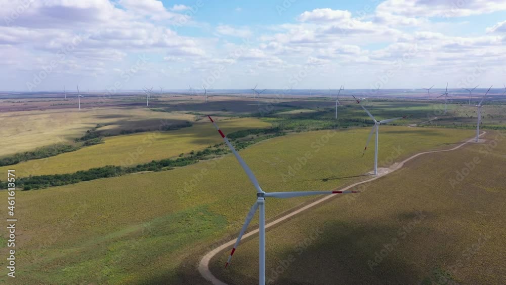 Aerial view over the farm landscape and wind turbines generating clean renewable energy. Renewable energy production for the green ecological world. Rostov, Russia