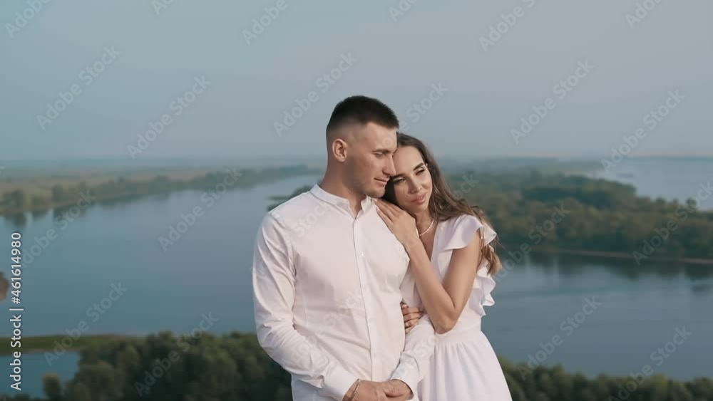 Outdoors. A beautiful girl hugs her boyfriend Outdoors. A beautiful girl hugs her boyfriend