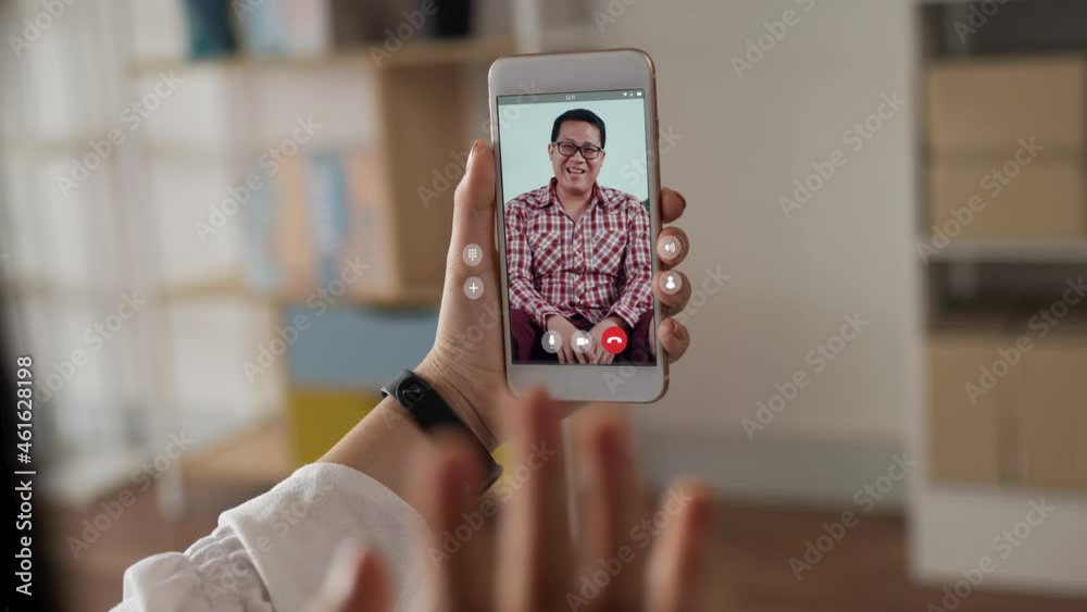Happy woman skype chatting on smartphone with father