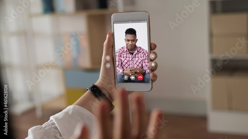 Happy woman skype chatting on smartphone with black people man photo