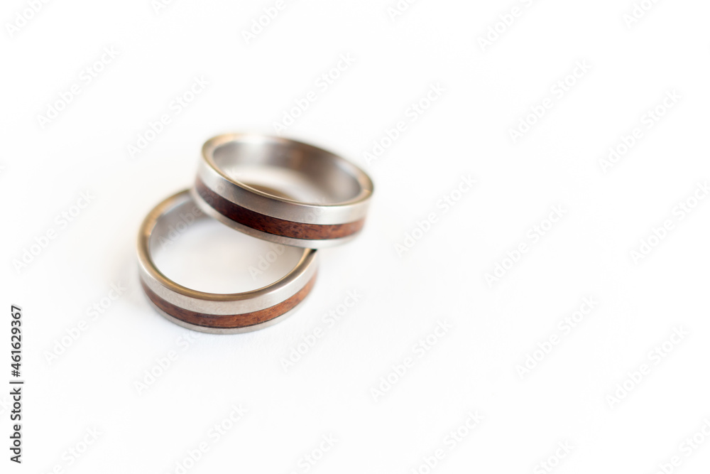 Wedding original rings titanium and wood on white background, jewellery Wedding original rings titanium and wood on white background, jewellery