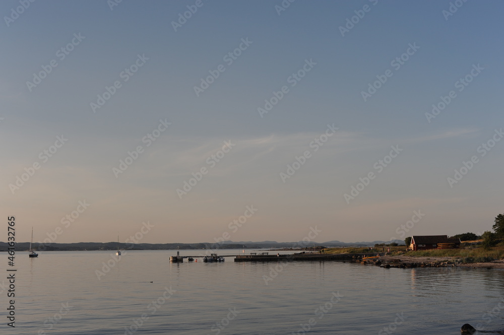 Pier or deck at Jomfruland island in Norway on a calm evening in summer Pier or deck at Jomfruland island in Norway on a calm evening in summer